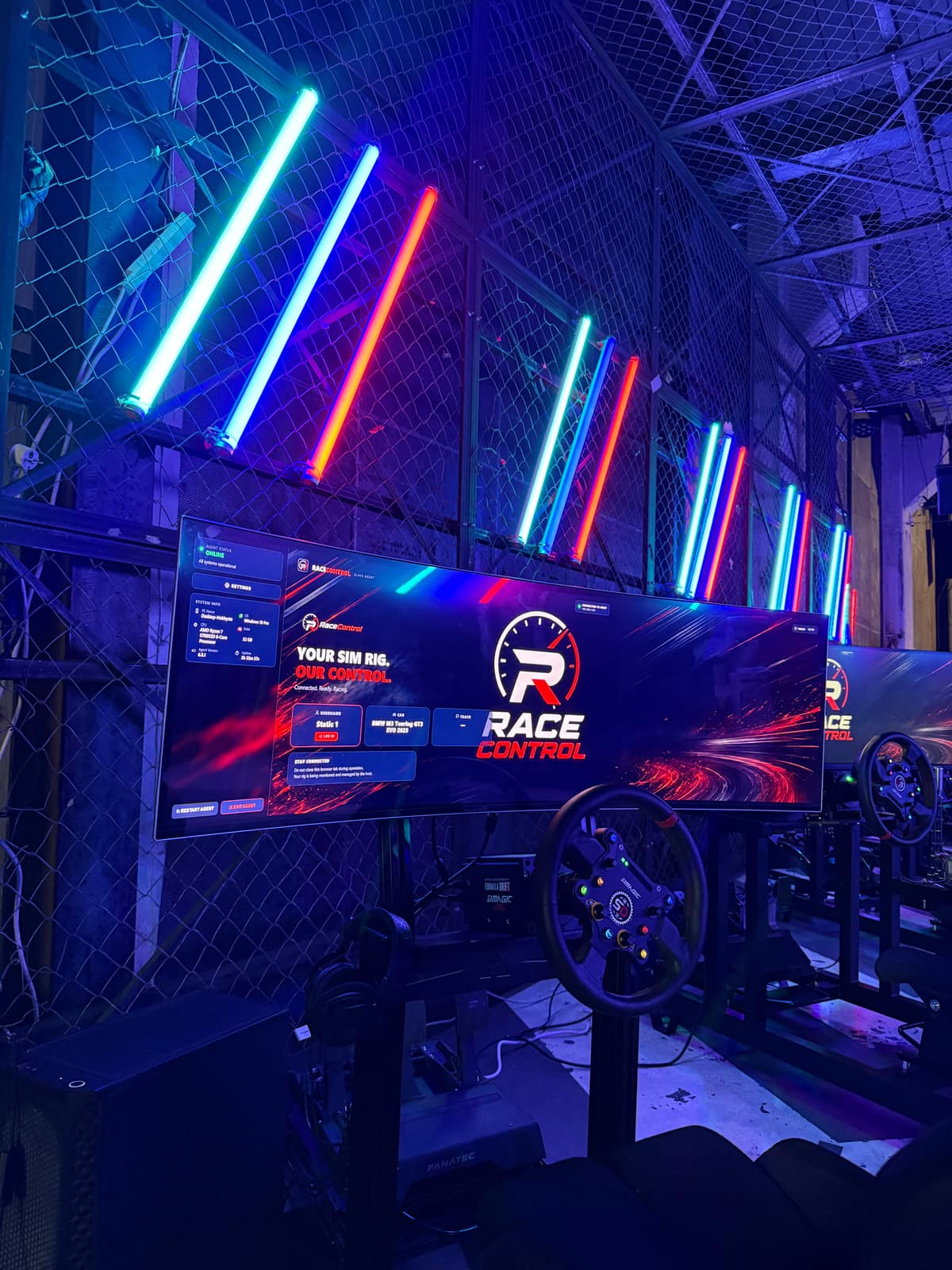 A simulator seat in front of a screen showing the RaceControl idle display