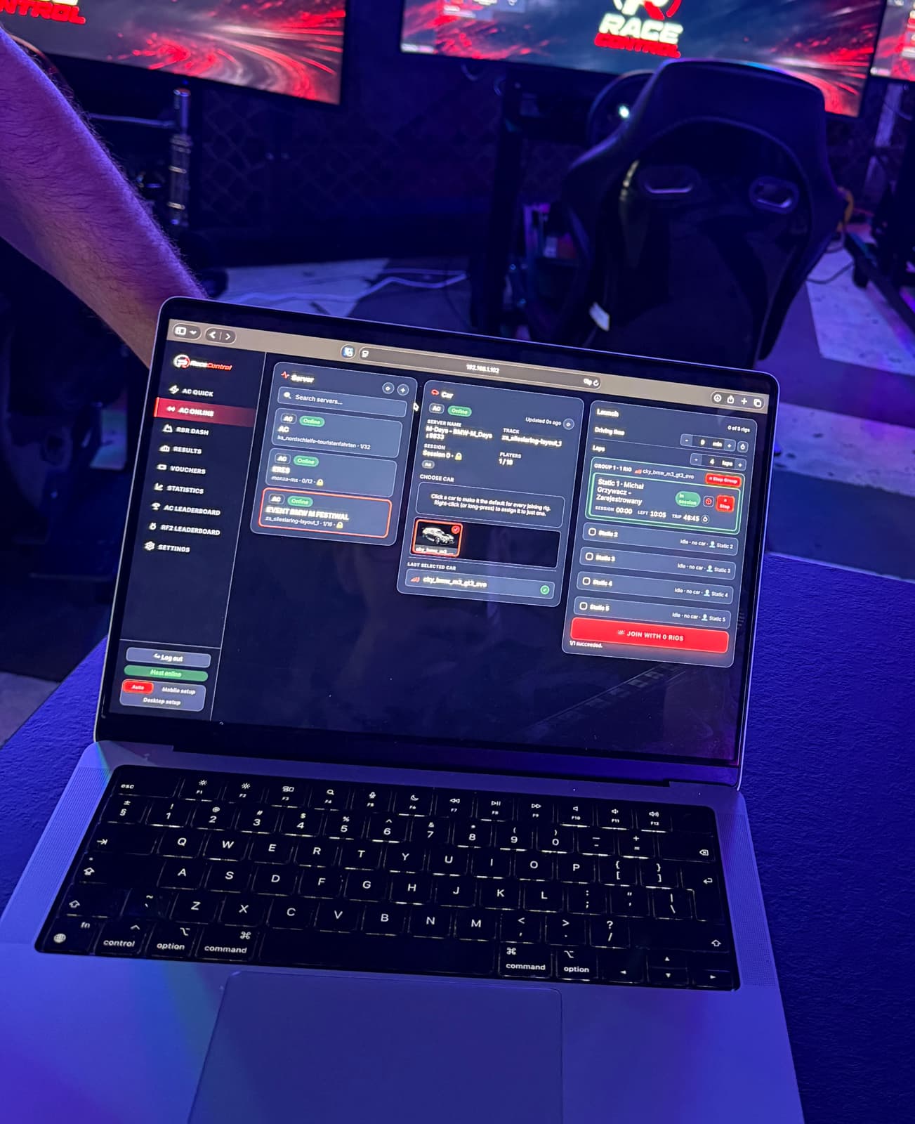 A laptop on the festival stand running the RaceControl operator dashboard