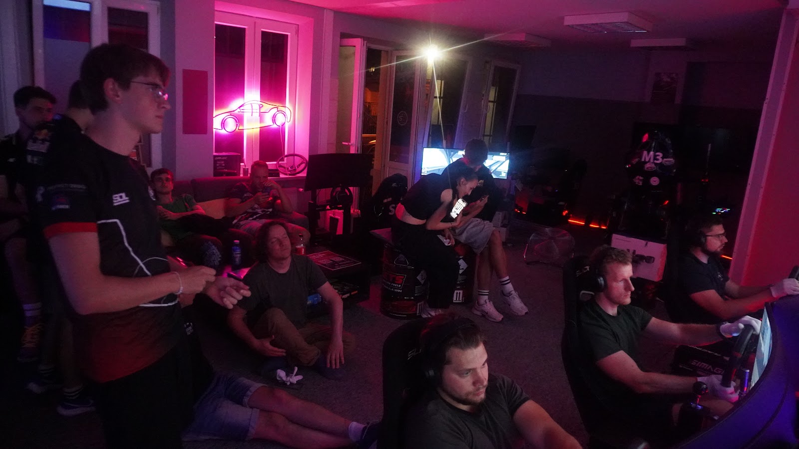 The row of simulators at SimRacingDream in Kraków with every seat taken by a league driver